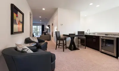 a living room with a couch and a table and a kitchen at Ultimate 5 Star Villa with Private Pool on Encore Resort at Reunion Orlando Villa 4391 in Orlando