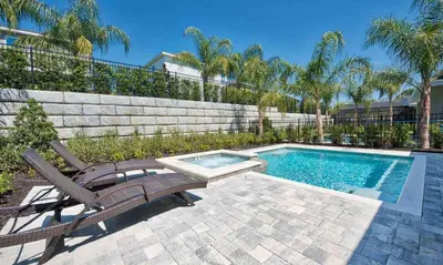 a swimming pool with two deckchairs and a bench next to a swimming pool at Luxury Private Villa with Large Pool on Encore Resort at Reunion Orlando Villa 4433 in Orlando