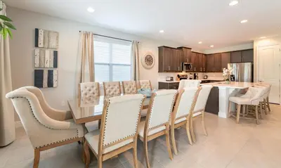 a dining room and kitchen with a table and chairs at Rent the Perfect 8 Bedroom Villa on Encore Resort at Reunion Orlando Villa 4474 in Orlando