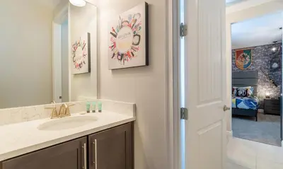 a bathroom with a sink and a mirror at Rent the Perfect 8 Bedroom Villa on Encore Resort at Reunion Orlando Villa 4474 in Orlando