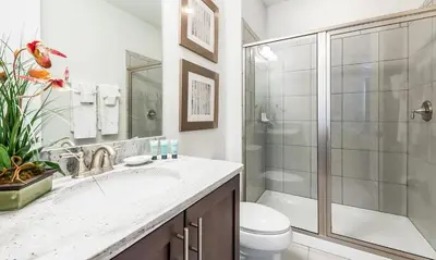 a bathroom with a shower and a toilet and a sink at 5 Star Villa on Orlando’s most Exclusive Encore Resort at Reunion Orlando Villa 4377 in Orlando