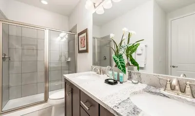 a bathroom with a sink and a shower and a toilet at 5 Star Villa on Orlando’s most Exclusive Encore Resort at Reunion Orlando Villa 4377 in Orlando
