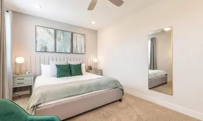 a bedroom with a large bed and a mirror at 5 Star Villa on Orlando’s most Exclusive Encore Resort at Reunion Orlando Villa 4507 in Orlando