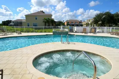 a swimming pool with a hot tub in the middle at Modern Townhome with 3 Bedrooms 5506 in Orlando