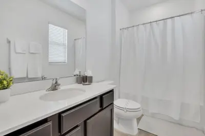 a white bathroom with a sink and a toilet at Amazing Mansion on Veranda Palms Resort with the Best 5 Star Amenities Orlando Mansion 5533 in Kissimmee