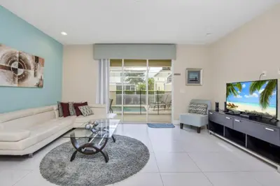 a living room with a couch and a flat screen tv at 3BR Townhome with Stunning Views 5528 in Orlando
