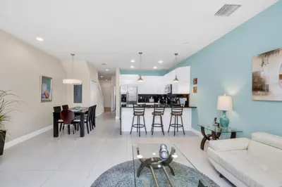 a living room with a couch and a table at 3BR Townhome with Stunning Views 5528 in Orlando