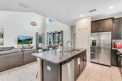 a kitchen and living room with a counter top at You Will Love this 5 Star Villa located on Storey Lake Resort Orlando villa 5492 in Kissimmee