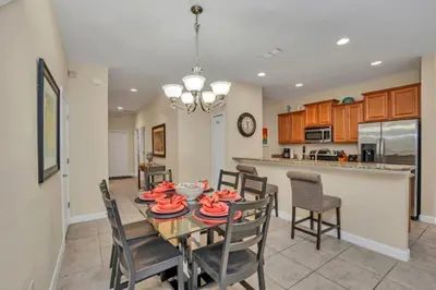 a dining room and kitchen with a table and chairs at Luxury 5 Star Villa on Paradise Palms ResortMinutes from Disney World Orlando Townhome 5502 in Kissimmee