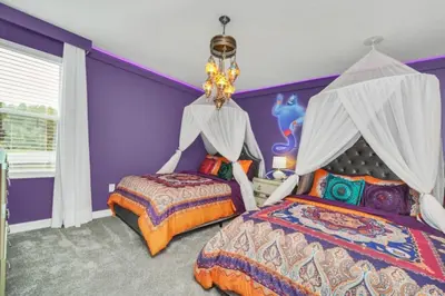 a purple bedroom with two beds and a chandelier at Modern 9 Bedroom Oasis for Large Groups 6272 in Kissimmee