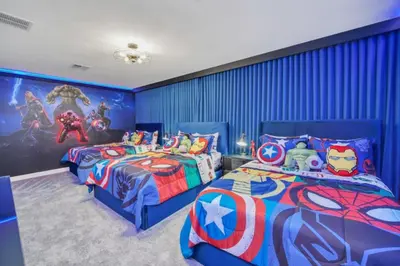 two beds in a room with a superhero mural at Modern 9 Bedroom Oasis for Large Groups 6272 in Kissimmee