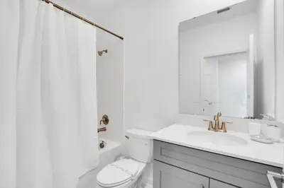 a white bathroom with a sink and a toilet at Ultimate 5 Bedroom Villa Escape 6314 in Kissimmee