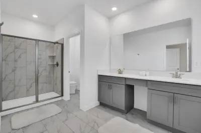 a white bathroom with a shower and a sink at Ultimate 5 Bedroom Villa Escape 6314 in Kissimmee