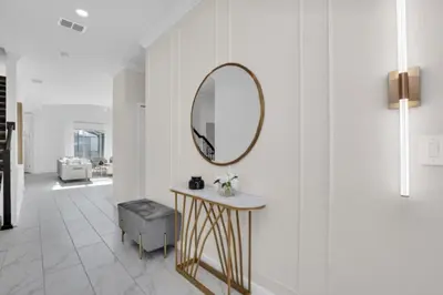 a bathroom with a mirror and a table and a stool at Ultimate 5 Bedroom Villa Escape 6314 in Kissimmee