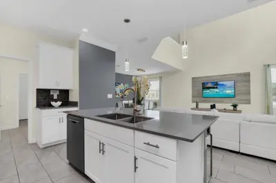 a kitchen with white cabinets and a sink at Escape to a 5 Bedroom Villa in Paradise 6316 in Kissimmee
