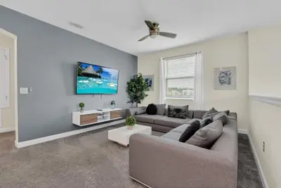 a living room with a couch and a tv at Escape to a 5 Bedroom Villa in Paradise 6316 in Kissimmee