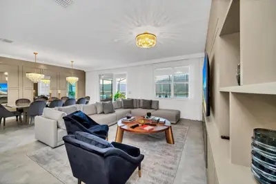 a living room with a couch and a table at Family-Friendly Villa with 9 Bedrooms 6317 in Kissimmee