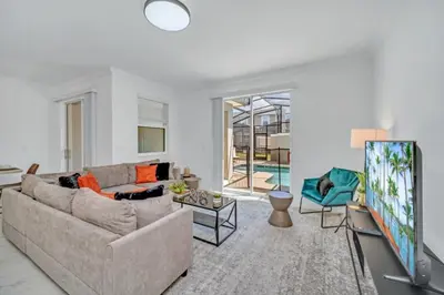 a living room with a couch and a tv at Cozy 4 Bedroom Urban Oasis 6326 in Kissimmee