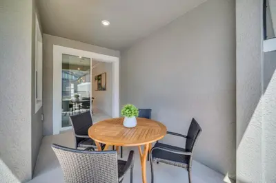 a dining room with a wooden table and chairs at Cozy 4 Bedroom Urban Oasis 6326 in Kissimmee