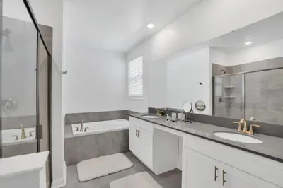 a white bathroom with two sinks and a bath tub at Private Oasis: 6 Bedroom Villa Retreat 6327 in Kissimmee