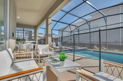 a conservatory with a swimming pool and glass walls at Private Oasis: 6 Bedroom Villa Retreat 6327 in Kissimmee