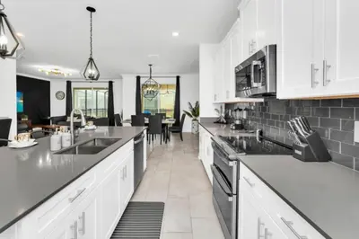 a kitchen with white cabinets and a counter top at Elegant Villa Retreat with Private Pool 6328 in Kissimmee