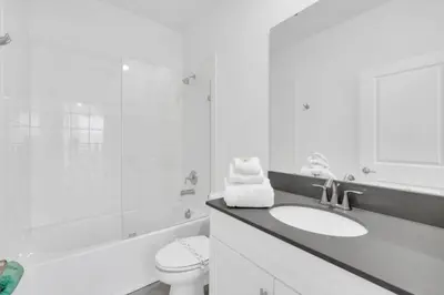 a white bathroom with a sink and a toilet at Elegant Villa Retreat with Private Pool 6328 in Kissimmee