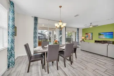 a dining room with a table and chairs at 6 Bedroom Villa with Tennis Court Gym 6332 in Kissimmee