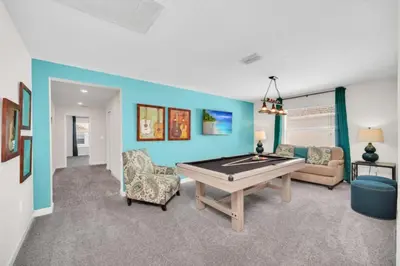 a living room with a ping pong table in it at 6 Bedroom Villa with Tennis Court Gym 6332 in Kissimmee