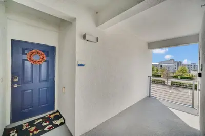 a room with a blue door and a balcony at Chic Urban Oasis with 3 Bedrooms 6333 in Kissimmee
