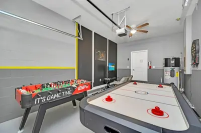 a ping pong table in a room with a game at Modern Villa with Game Room Theater 6334 in Kissimmee