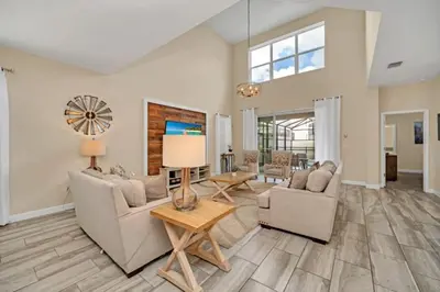 a living room with two couches and a table at Modern Villa with Game Room Theater 6334 in Kissimmee