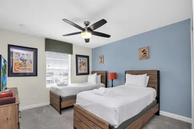 a bedroom with two beds and a ceiling fan at Modern 4 Bedroom Villa near Beach Shopping 6335 in Kissimmee