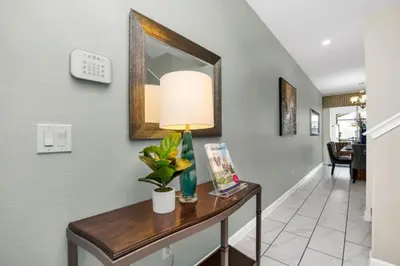 a hallway with a table with a lamp on it at Modern 4 Bedroom Villa near Beach Shopping 6335 in Kissimmee