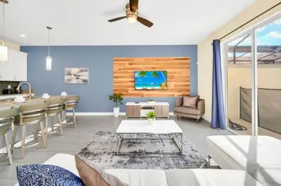 a living room with blue walls and a ceiling fan at Your Ultimate Vacation Getaway 6336 in Kissimmee