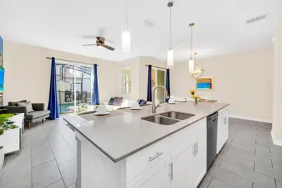 a kitchen with a sink and a living room at Your Ultimate Vacation Getaway 6336 in Kissimmee