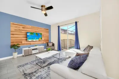 a living room with a white couch and a tv at Your Ultimate Vacation Getaway 6336 in Kissimmee