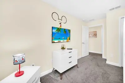 a living room with a white dresser and a desk at Your Ultimate Vacation Getaway 6336 in Kissimmee