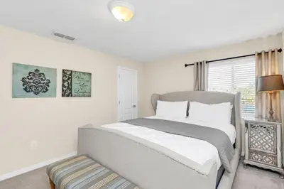 a white bedroom with a bed and a window at Spacious 5 Bedroom Villa for Families 6337 in Kissimmee