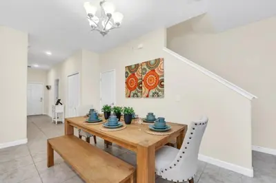 a dining room with a wooden table and chairs at Spacious 5 Bedroom Villa for Families 6337 in Kissimmee