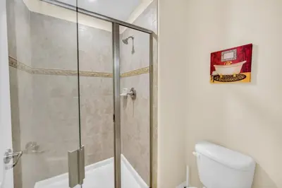 a bathroom with a shower with a toilet and a sink at Tranquil Villa Retreat with Mountain Views 6338 in Kissimmee