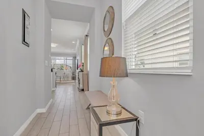 a lamp sitting on a table in a hallway at Cozy 4BR Cottage with Fireplace 6379 in Kissimmee