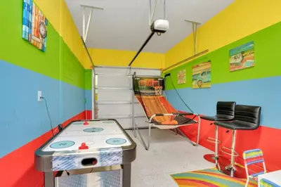 a colorful childs room with a table and a slide at Cozy 4BR Cottage with Fireplace 6379 in Kissimmee