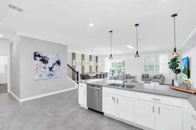 a kitchen with white cabinets and a large kitchen island at Spacious Villa Retreat with 9 Bedrooms 6381 in Kissimmee