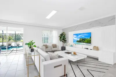 a white living room with a couch and a table at Spacious Villa Retreat with 9 Bedrooms 6381 in Kissimmee