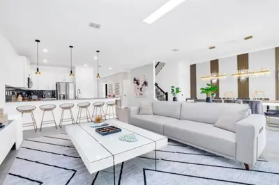 a living room with a white couch and a table at Spacious Villa Retreat with 9 Bedrooms 6381 in Kissimmee