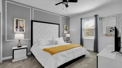 a bedroom with a bed and a ceiling fan at Rent the Perfect 8 Bedroom Villa on Storey Lake Resort Orlando Villa 6293 in Kissimmee