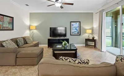 a living room with couches and a flat screen tv at Beautiful House with first class amenities on Paradise Palms Resort Orlando House 6298 in Kissimmee