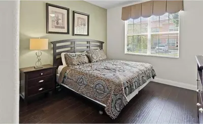 a bedroom with a bed and a window at Beautiful House with first class amenities on Paradise Palms Resort Orlando House 6298 in Kissimmee