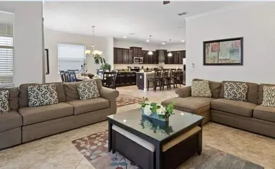 a living room with a couch and a table at Beautiful House with first class amenities on Paradise Palms Resort Orlando House 6298 in Kissimmee